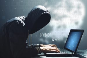 Hacker with laptop initiating the hacker attack, cyber war